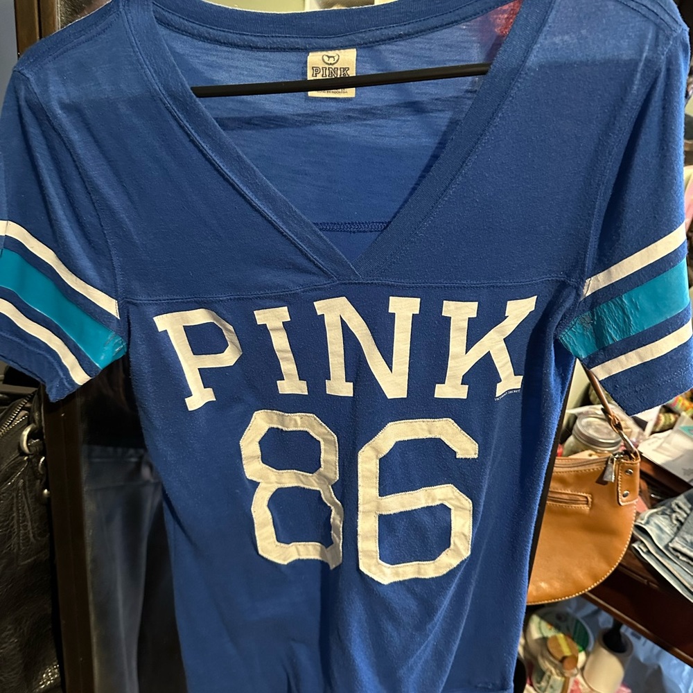 Pink vintage tee. Some wear on sleeves.